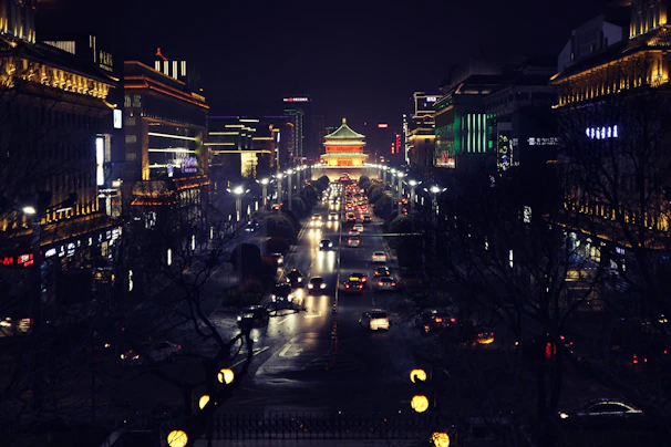 A bustling cityscape of Santo Domingo at night with illuminated buildings and traffic.