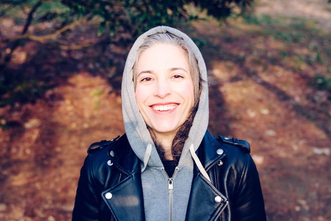 woman smiling near tree