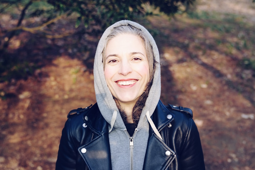 woman smiling near tree