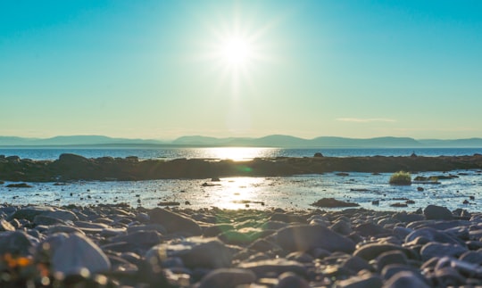 body of water under blue sky during daytime in Rivière-du-Loup Canada