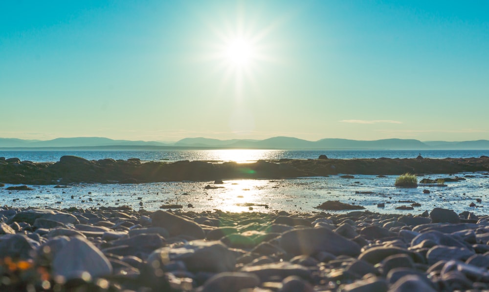 body of water under blue sky during daytime