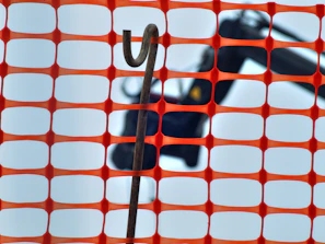 Close-up of a steelguard galvanized crowd control barrier with interlocking hooks on a construction site.