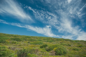 A vibrant photo of Morro do Chapéu's lush green hills under a bright blue sky.