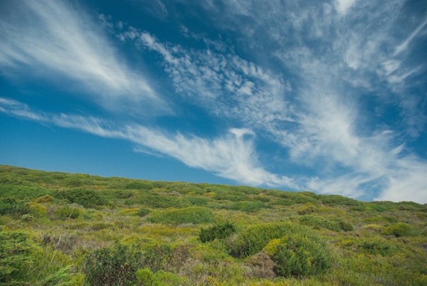 A vibrant photo of Morro do Chapéu's lush green hills under a bright blue sky.
