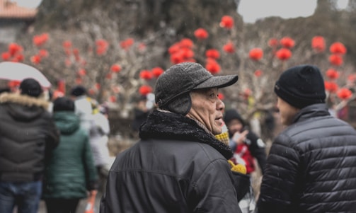 A group of volunteers handing out warm clothing to people outdoors.