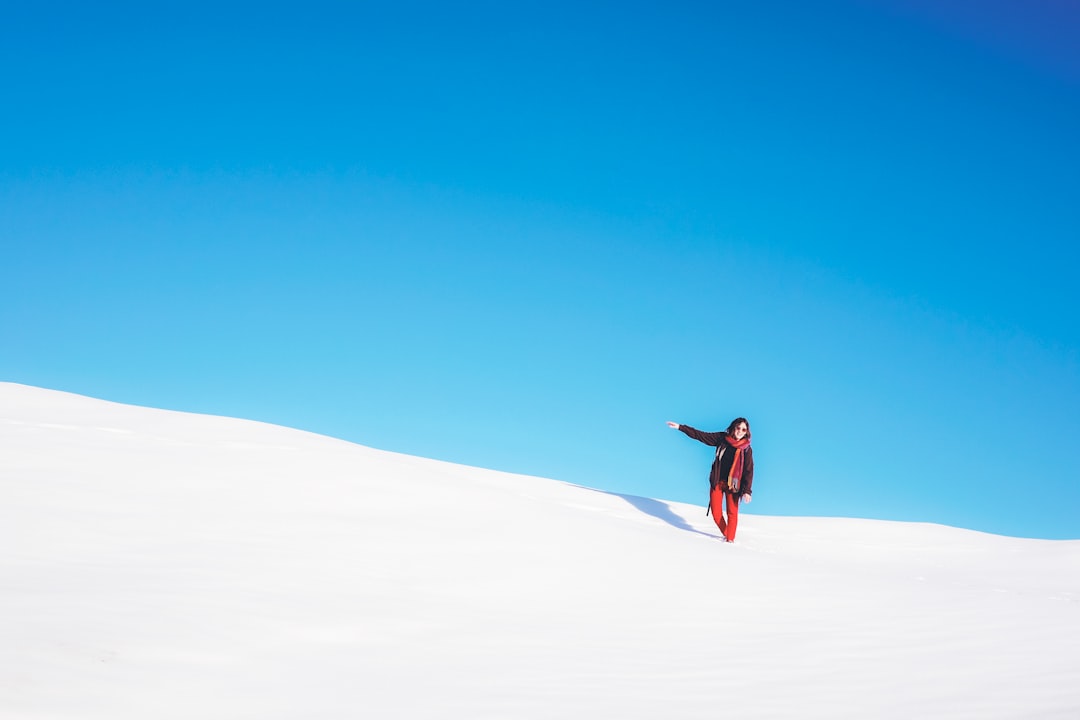 woman standing on white snow field during daytime