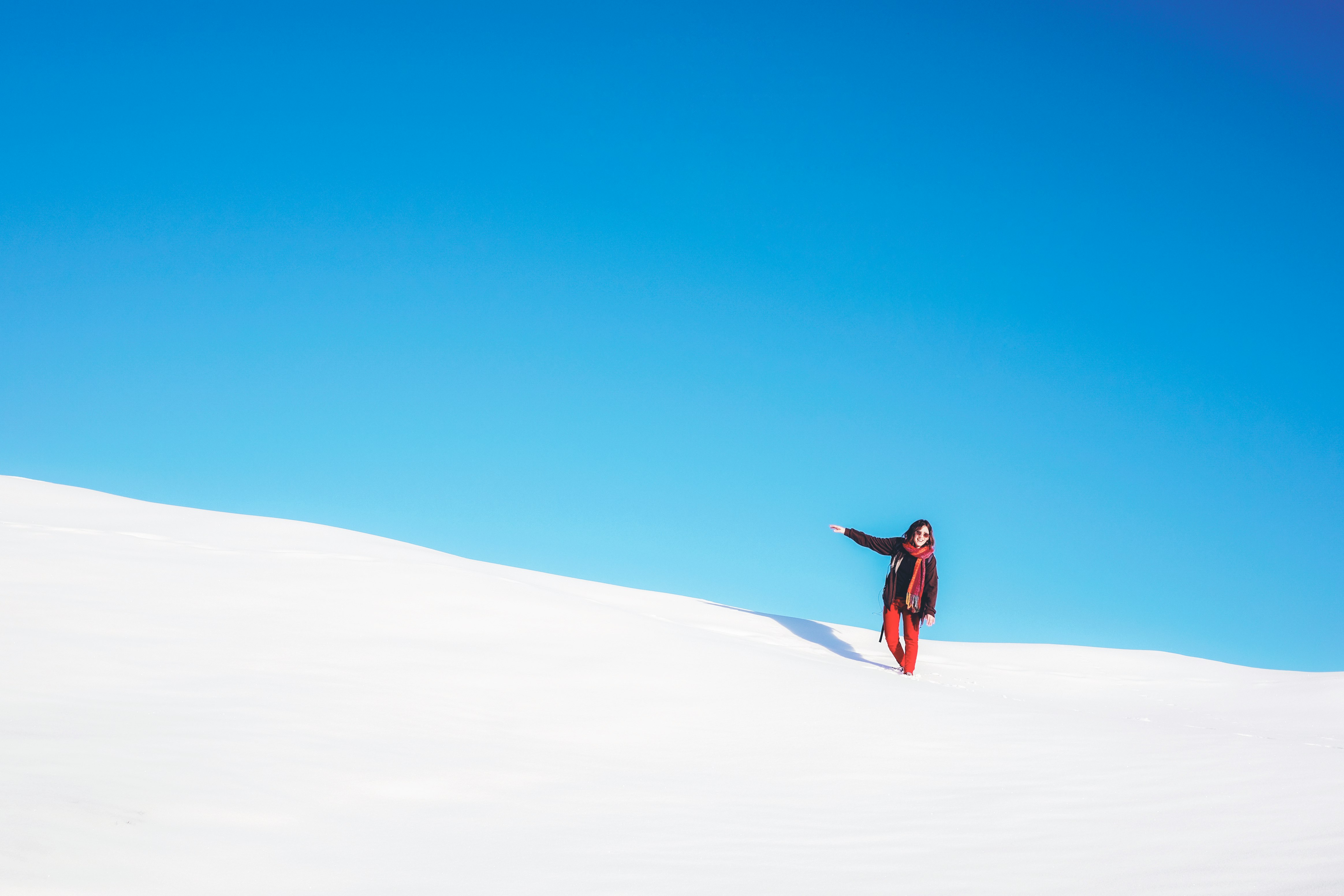 woman standing on white snow field during daytime