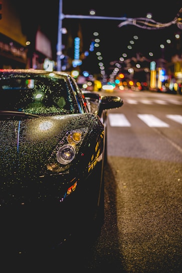 A sleek car wrapped in vibrant protective film parked on a city street.