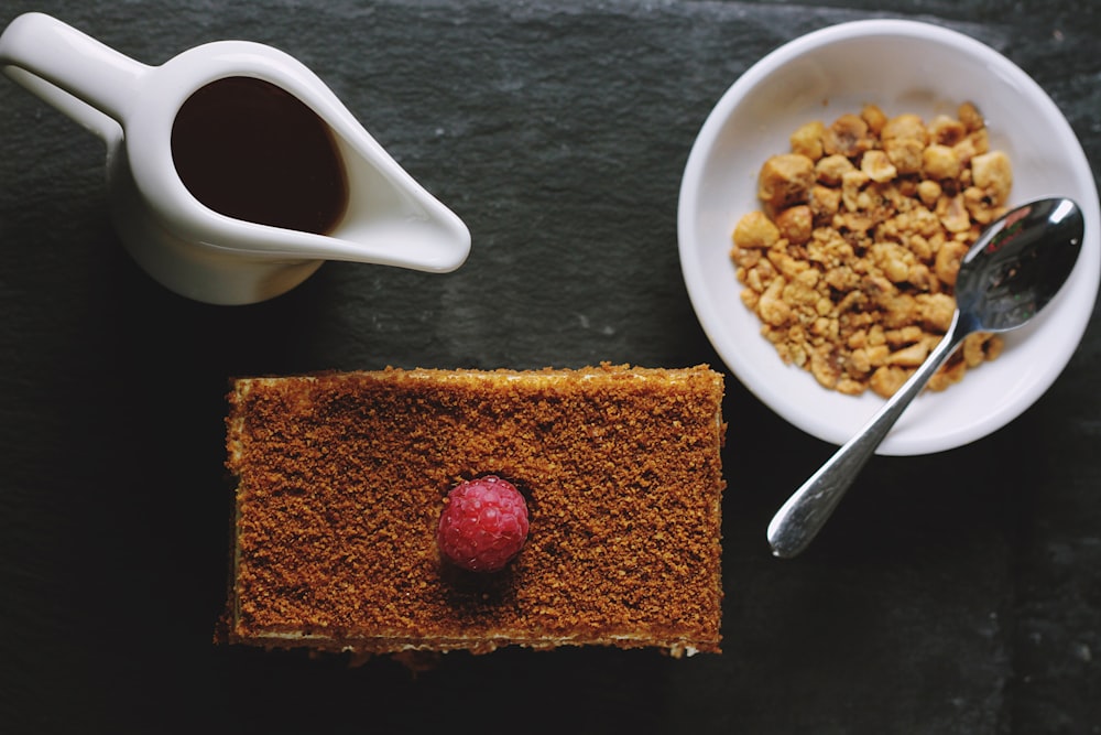 Flat lay of breakfast cake, syrup, and hazelnuts