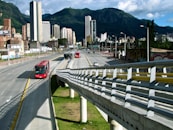 A modern cityscape with smart transportation options like buses and bikes.