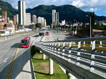 A city street with smart traffic lights and electric buses moving smoothly through green urban spaces.
