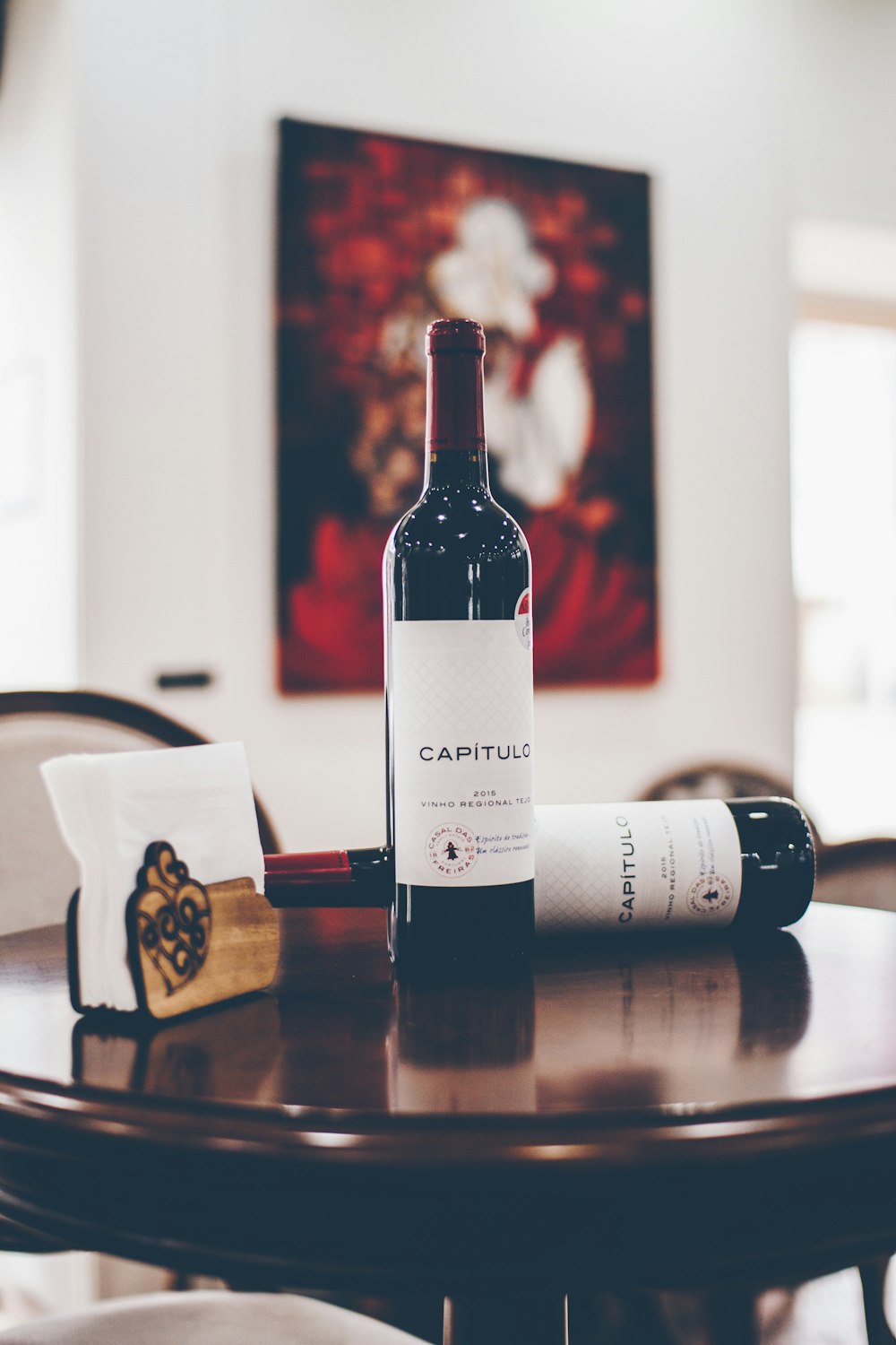 selective focus photography of two Capitulo bottles on table