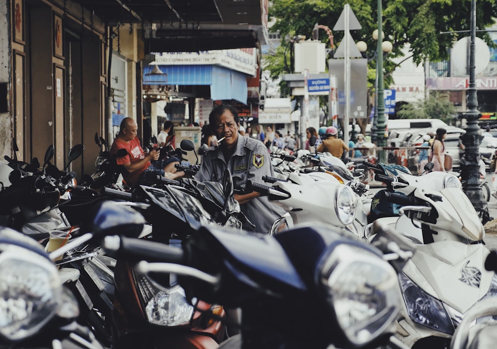 man on motor scooter smoking cigarette