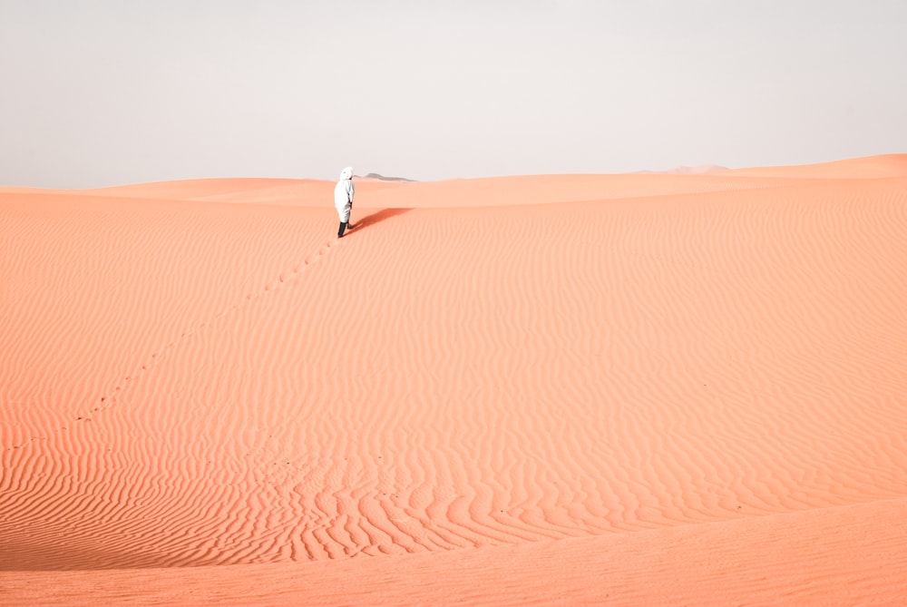 person walking on desert during daytime