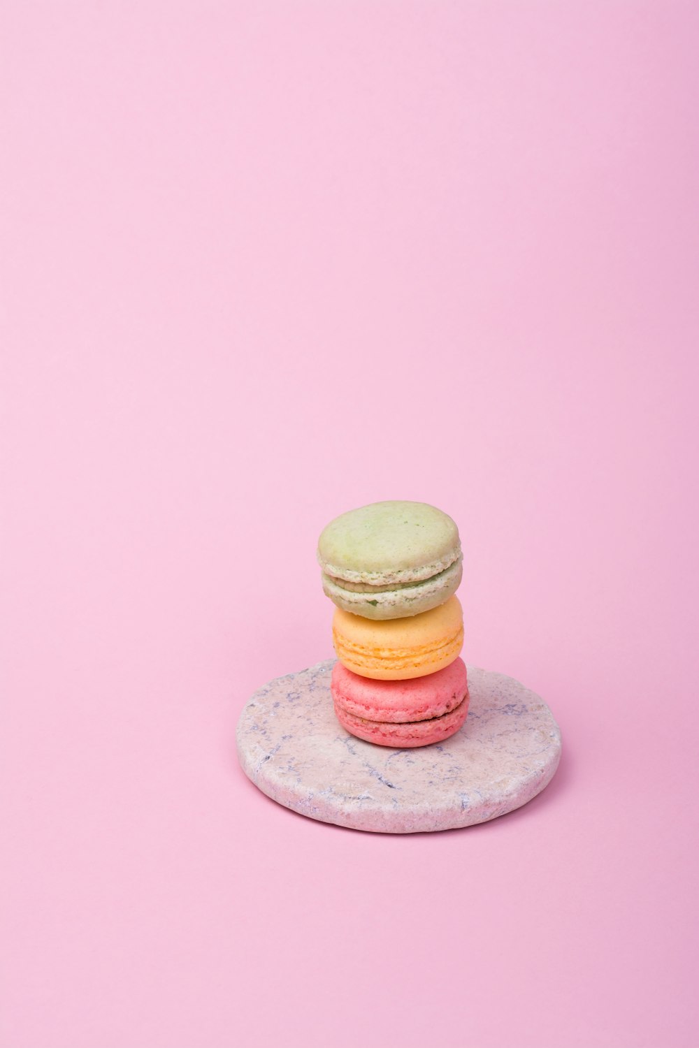 three French macaroons on plate