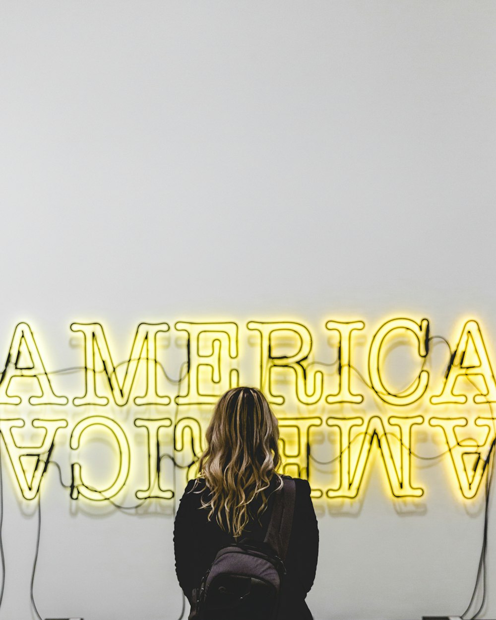 woman in front American lighted signage