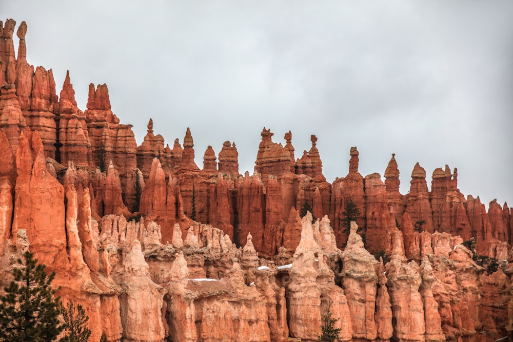 brown rock formation under white clouds during daytime