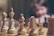 beige chess piece on board in selective focus photography
