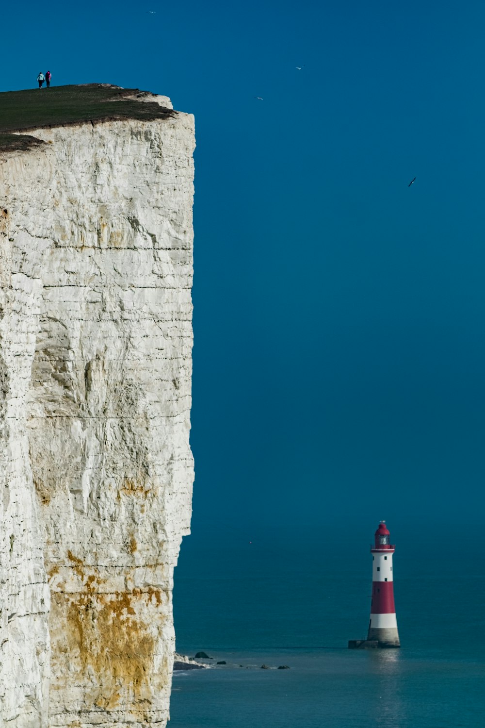 lighthouse on body of water \