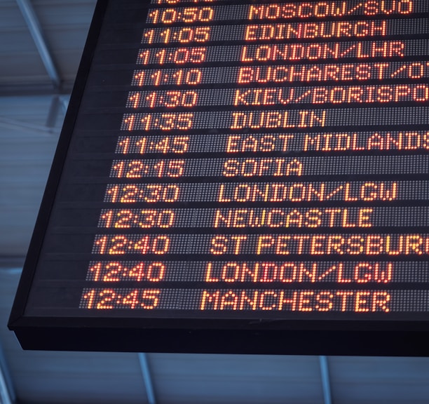 A low-angle shot of a departure board at an airport