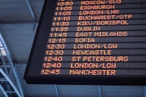 fish farmers scans departure board at airport