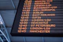 A low-angle shot of a departure board at an airport