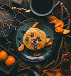 pancakes with orange and blueberry on plate