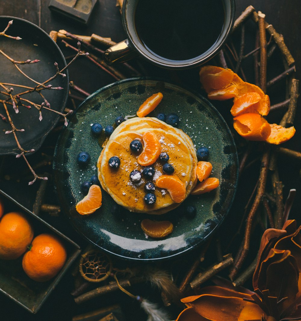 pancakes with orange and blueberry on plate