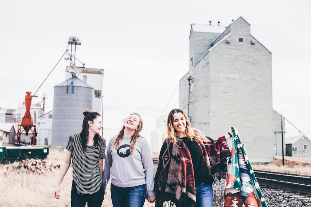 three women walking from industrial location