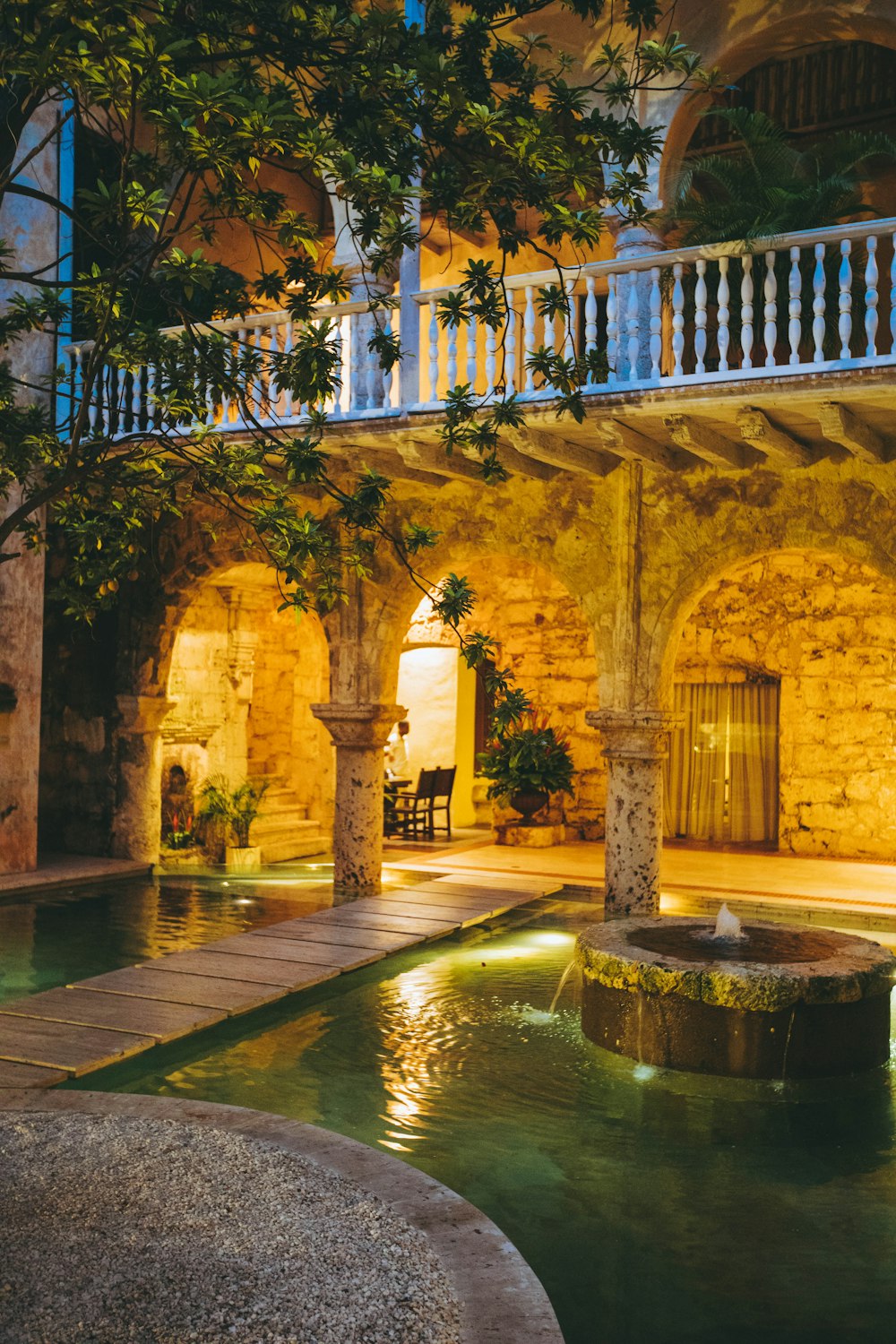 modern house with water fountain and swimming pool showing lighted ceiling lights