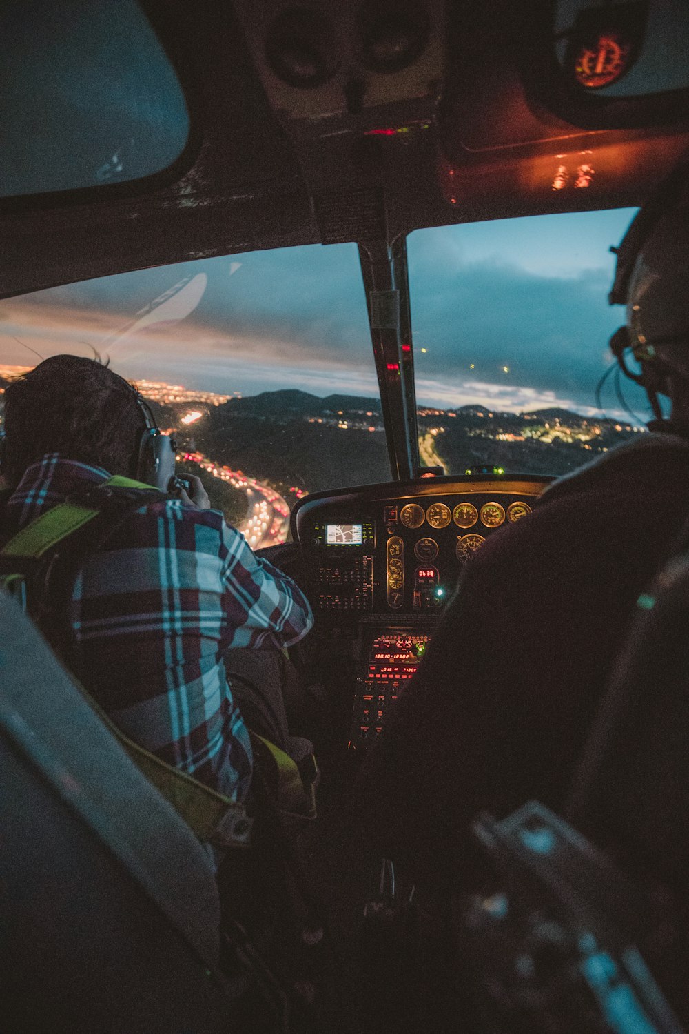 Photographie d’un homme à bord d’un hélicoptère pendant la nuit