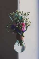 A bouquet of fresh flowers arranged inside a clear balloon, perfect for a heartfelt proposal.