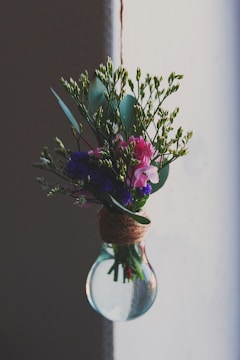 A bouquet of fresh flowers arranged inside a clear balloon, perfect for a heartfelt proposal.