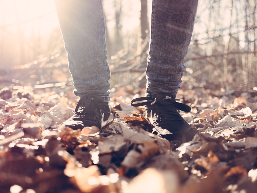 person wearing black running shoes