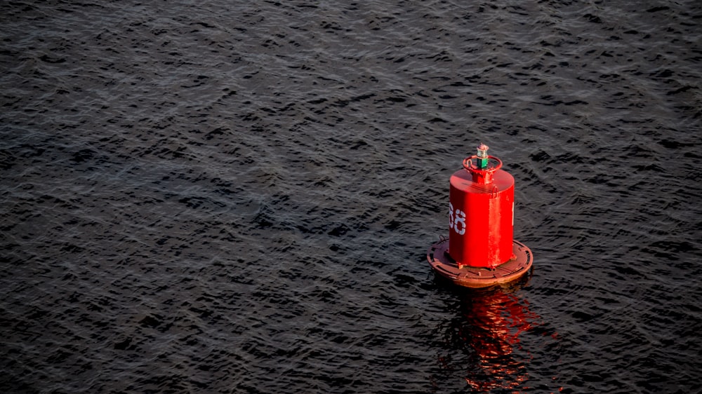 red buoy on body of water