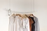 assorted clothes in wooden hangers