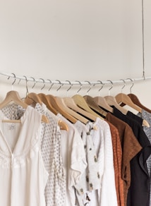 assorted clothes in wooden hangers