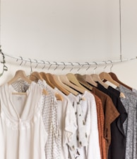 assorted clothes in wooden hangers