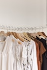 assorted clothes in wooden hangers