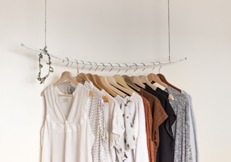 assorted clothes in wooden hangers