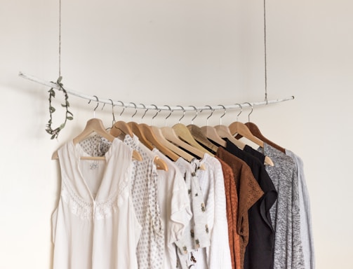 assorted clothes in wooden hangers