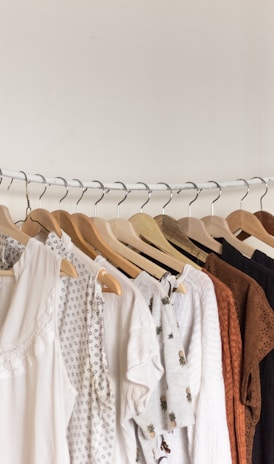 assorted clothes in wooden hangers