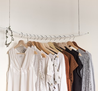 assorted clothes in wooden hangers