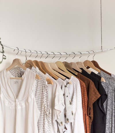 assorted clothes in wooden hangers