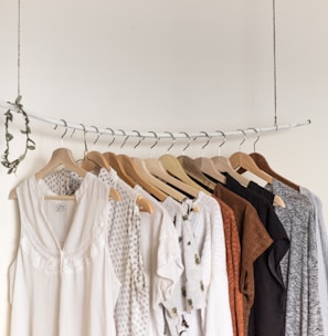 assorted clothes in wooden hangers