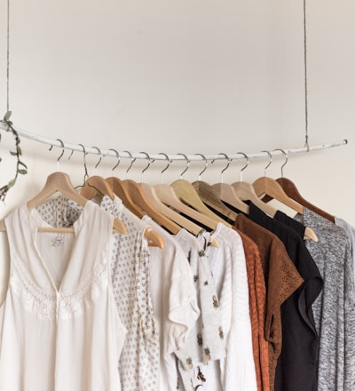 assorted clothes in wooden hangers