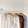 assorted clothes in wooden hangers