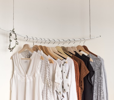 assorted clothes in wooden hangers