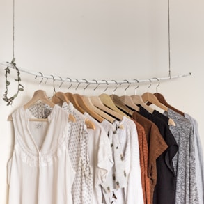 assorted clothes in wooden hangers