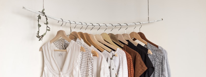 assorted clothes in wooden hangers